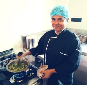 a woman cooking food on a stove